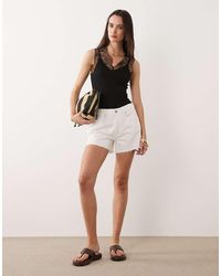 GOOD AMERICAN - Vintage Mid Rise Longline Denim Shorts - Lyst