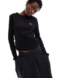 Calvin Klein - Top a maniche lunghe a coste con etichetta cucita - Lyst