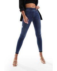 Spanx - Vaqueros De Corte Pitillo Con Diseño Moldeador Desgastado Y Lavado Azul Medio De - Lyst