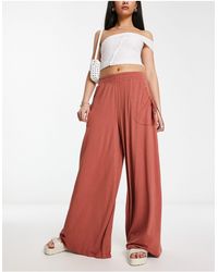 ASOS - Pantaloni a fondo ampio color ruggine con tasche e vita arricciata - Lyst
