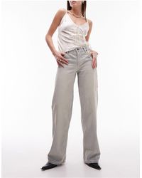 TOPSHOP - Ember - jeans a vita bassa con fondo ampio candeggiati effetto sporco - Lyst