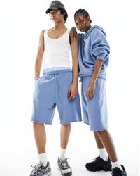 ASOS - Pantalones cortos azul denim lavado estilo bermudas unisex extragrandes con bajo sin rematar - Lyst