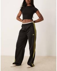 adidas Originals - Pantalones De Chándal Negros Y Amarillos De Corte Suelto Firebird De - Lyst