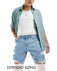 ASOS - Pantaloncini di jeans lunghi lavaggio chiaro con abrasioni - Lyst