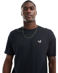 Hollister - Camiseta negra holgada con logo bordado - Lyst