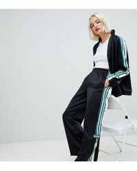 pantaloni con bottoni adidas