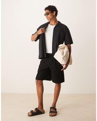 ASOS - Short mi-long ample en jean noué devant - délavé - Lyst