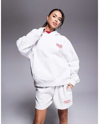 Kaiia - Studio - sweat à capuche d'ensemble oversize à inscription running club - Lyst