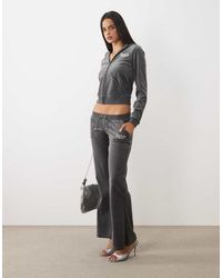 Juicy Couture - Caisa Regal Logo Rebelle Ultra Low Rise Velour jogger - Lyst