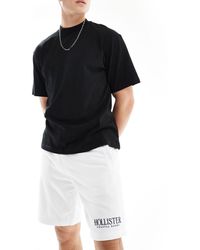 Hollister - Pantaloncini della tuta da 9" bianchi tecnici con logo - Lyst