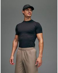4505 - T-Shirt Base Layer A Compressione Attillata Nera Senza Cuciture Che Definisce Il Fisico - Lyst