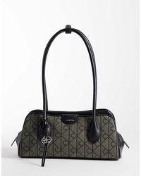 Calvin Klein - Emblem Shoulder Bag With Hardware Charm And All Over Emblem Print - Lyst