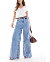 ASOS - Vaqueros De Talle Alto Y Pernera Ancha Con Lavado Azul Medio Y Cinturón De - Lyst