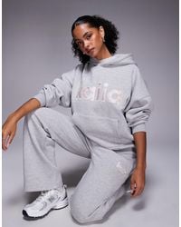 Kaiia - Sweat à capuche d'ensemble oversize en coton majoritaire avec logo brodé - clair et rose - Lyst