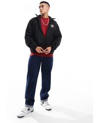 Tommy Hilfiger - Chaqueta Negra Reversible Con Detalle De Escudo De Tejido Tipo Peluche De - Lyst