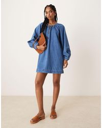 ASOS - Robe courte en jean avec manches ballon - moyen délavé - Lyst