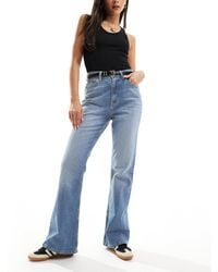ASOS - Jean évasé à taille mi-haute - moyen - Lyst