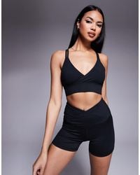 4505 - Light Support Strappy Sports Bra With Adjustable Straps - Lyst