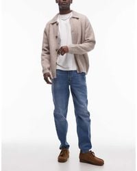TOPMAN - Vaqueros Azules Elásticos De Corte Tapered Con Lavado Medio De - Lyst