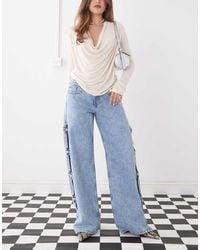 Monki - Imoo Low Waist Wide Leg Jeans With Cut Out Bow Details - Lyst