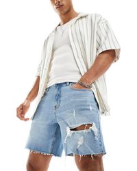 ASOS - Pantaloncini di jeans slim taglio medio con strappi lavaggio chiaro - Lyst