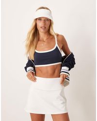 4505 - Light Support Sports Bra With Contrast Piping And Removable Padding - Lyst
