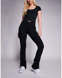 4505 - Hourglass Icon Wrap Waist Slim Kick Yoga legging - Lyst