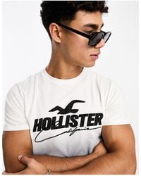 Hollister - Camiseta blanca y negra con diseño degradado y aplicación - Lyst
