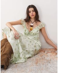 Reclaimed (vintage) - Robe longues à fleurs avec bretelles et manches évasées - vert - Lyst