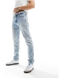 Calvin Klein - Jeans slim affusolati lavaggio chiaro - Lyst