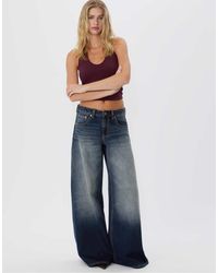Stradivarius - – d66 – jeans mit niedrigem bund, sehr weitem bein und mittlerer denim-waschung - Lyst
