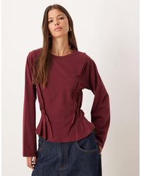 ASOS - T-shirt corseté à manches longues et surpiqûres - bordeaux - Lyst