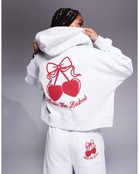 Kaiia - Studio - sweat à capuche zippé court d'ensemble en coton majoritaire à imprimé cerise au dos - chiné et rouge - Lyst