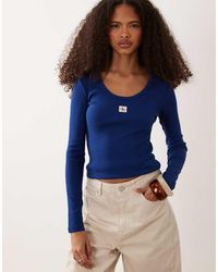 Calvin Klein - Geribbelde Top Met Lange Mouwen, Geweven Label En Lage Ronde Hals - Lyst
