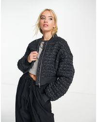 & Other Stories - Giacca bomber nera a punto smock - Lyst