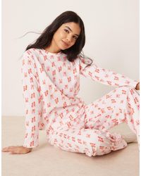 ASOS - Pyjama avec pantalon et top à manches longues et imprimé nœuds - /rouge - Lyst