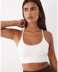 4505 - Icon Light Support Sports Bra With Adjustable Straps - Lyst
