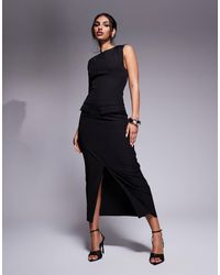 Kaiia - Exclusivité - robe longue habillée fendue sans manches avec col montant et poches - Lyst