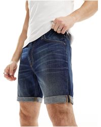 Lee Jeans - Rider - short en jean slim - bleu foncé délavé - Lyst