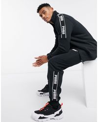 all black puma tracksuit