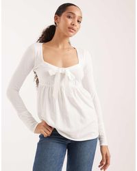 Hollister - Long Sleeve Front Bow Babydoll Top - Lyst