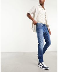 Tommy Hilfiger - Austin - jeans slim affusolati lavaggio medio - Lyst