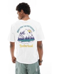Timberland - T-shirt oversize bianca con stampa di paesaggio di montagna sul retro - Lyst