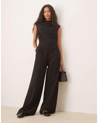 Mango - Tuta Jumpsuit Nera Con Cintura E Maniche Ad Aletta - Lyst