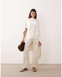 ARRANGE - Tova Tapered Curved Leg Jeans With Roll Hem - Lyst