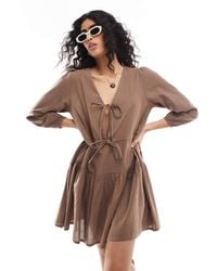 esmé studios - Esmee Exclusive Linen Mix Long Sleeve Tiered Mini Tie Front Beach Dress - Lyst