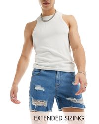 ASOS - Pantaloncini di jeans taglio corto lavaggio medio con strappi - Lyst