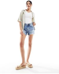 Bershka - Short en jean à taille haute avec déchirures - moyen - Lyst