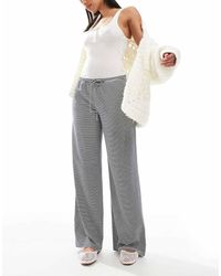 Hollister - Pantaloni Ampi A Vita Bassa A Righe Nere E Bianche - Lyst