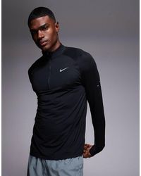 Nike - Camiseta Negra De Manga Larga Con Media Cremallera Dri-Fit Stride De - Lyst